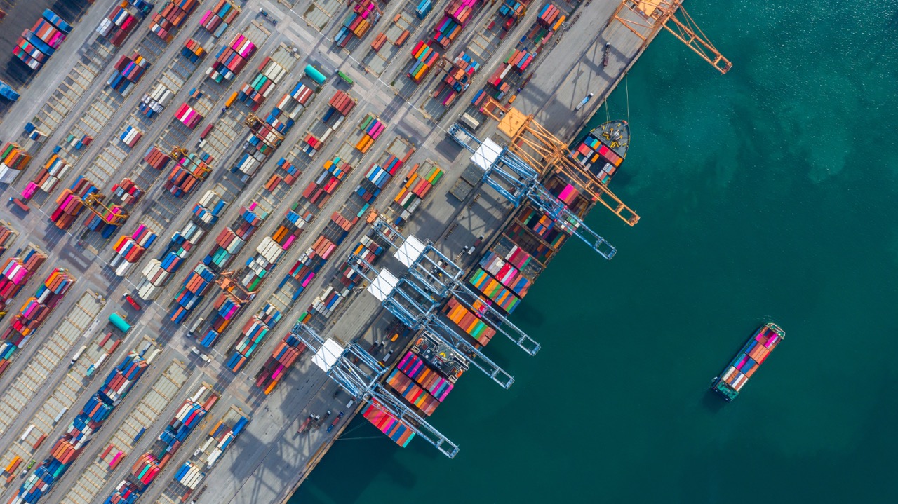 Aerial view of a busy shipping port, representing global logistics and market reach